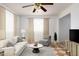 Cozy living room with plush seating, decorative rug, and ample natural light creating a welcoming space at 1309 Jackson St, Burlington, NC 27217