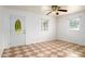 Open-concept living room with abundant natural light, tiled floors, and a front door and multiple windows at 1309 Jackson St, Burlington, NC 27217