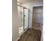 Bathroom featuring glass enclosed shower with view to a carpeted walk in closet at 132 Rockfall Way, Rocky Mount, NC 27803