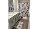 Bright bathroom features a double sink vanity, wood-look floors, and unique Mickey Mouse shower curtain at 132 Rockfall Way, Rocky Mount, NC 27803