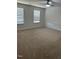 Large bedroom with plush carpet, neutral walls, and a ceiling fan for added comfort at 132 Rockfall Way, Rocky Mount, NC 27803