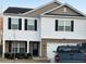 Charming two-story home featuring white siding, black shutters, and an attached two-car garage at 132 Rockfall Way, Rocky Mount, NC 27803