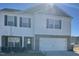 Two-story home with white siding, black shutters, and a two-car garage at 132 Rockfall Way, Rocky Mount, NC 27803