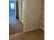 Hallway with wood flooring leading to a bright bedroom and a glimpse of the walk-in closet at 132 Rockfall Way, Rocky Mount, NC 27803