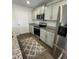 Charming kitchen features stainless steel appliances, granite countertops, and white cabinets at 132 Rockfall Way, Rocky Mount, NC 27803