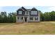 Charming two-story home with a welcoming front porch and a mix of brick and siding exterior at 1406 Reading Ct # 93 Kl, Burlington, NC 27217