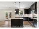 Charming kitchen with stainless appliances, granite countertops, and a large center island with a view of the porch at 1406 Reading Ct # 93 Kl, Burlington, NC 27217
