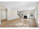 Inviting living room with a fireplace, large windows, and laminate flooring at 1406 Reading Ct # 93 Kl, Burlington, NC 27217