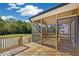 Spacious screened-in porch with wooden decking and black railings, perfect for outdoor relaxation at 1406 Reading Ct # 93 Kl, Burlington, NC 27217