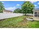 Backyard with a green lush lawn, trees, and a new vinyl privacy fence at 149 Cinder Cross Way, Garner, NC 27529