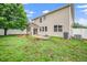 Wide open backyard with new vinyl privacy fence, home, and lush green lawn at 149 Cinder Cross Way, Garner, NC 27529