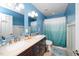Bright bathroom with dual sinks, shower, toilet and bath amenities at 149 Cinder Cross Way, Garner, NC 27529