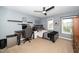 Bedroom with grey walls, ceiling fan, computer setup, and bed with two windows allowing for great natural light at 149 Cinder Cross Way, Garner, NC 27529