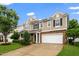 Well-maintained two-story home with a large driveway, tidy lawn, and a side-entry two-car garage at 149 Cinder Cross Way, Garner, NC 27529