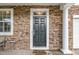Charming front entrance with brickwork, a new door, and a 'Home Sweet Home' welcome mat at 149 Cinder Cross Way, Garner, NC 27529