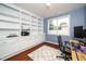 Inviting home office features custom built-ins, a large window and stylish, modern decor at 149 Cinder Cross Way, Garner, NC 27529