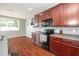 This stylish kitchen has dark wood cabinets, modern appliances and sleek countertops for the home chef at 149 Cinder Cross Way, Garner, NC 27529