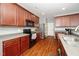 Well-equipped kitchen with wood cabinetry, modern appliances, and ample counter space for food preparation at 149 Cinder Cross Way, Garner, NC 27529