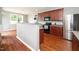 Well-designed kitchen features dark wood cabinets, stainless steel appliances, and a convenient breakfast bar at 149 Cinder Cross Way, Garner, NC 27529