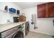 Bright laundry room with front-loading washer and dryer plus folding space at 149 Cinder Cross Way, Garner, NC 27529