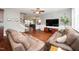 Open concept living room features wood floors, comfortable seating, and a bright and airy atmosphere at 149 Cinder Cross Way, Garner, NC 27529