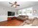 Spacious living room with large windows offering natural light, a ceiling fan, and comfortable seating at 149 Cinder Cross Way, Garner, NC 27529