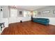 Open living area with lots of natural light, beautiful wood floors, and a comfy couch at 149 Cinder Cross Way, Garner, NC 27529