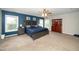 Stylish main bedroom featuring a coffered ceiling, neutral carpet, and abundant natural light at 149 Cinder Cross Way, Garner, NC 27529