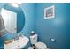 Charming powder room is freshly painted with a modern sink, toilet and stylish decorations at 149 Cinder Cross Way, Garner, NC 27529