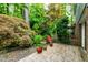 Charming backyard patio is surrounded by lush landscaping, creating a serene outdoor space at 1513 Dellwood Dr, Raleigh, NC 27607