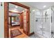 Primary bath with walk-in shower and a doorway view into main bedroom at 1513 Dellwood Dr, Raleigh, NC 27607