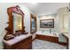 Elegant primary bathroom with antique vanity, custom mirror, and soaking tub at 1513 Dellwood Dr, Raleigh, NC 27607