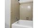 Bathroom features a traditional bathtub with chrome fixtures and neutral tiling at 1513 Dellwood Dr, Raleigh, NC 27607