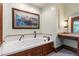 Bright bathroom features a built-in soaking tub and a vanity area at 1513 Dellwood Dr, Raleigh, NC 27607