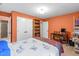 Cozy bedroom features closet and a quaint desk setup with natural light at 1513 Dellwood Dr, Raleigh, NC 27607