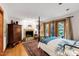 Spacious primary bedroom featuring hardwood floors, a fireplace and direct access to backyard at 1513 Dellwood Dr, Raleigh, NC 27607