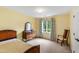 Yellow bedroom with beautiful wood dresser and window at 1513 Dellwood Dr, Raleigh, NC 27607