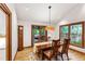 Bright dining room featuring hardwood floors and views of the greenery outside at 1513 Dellwood Dr, Raleigh, NC 27607