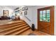 Inviting entryway with wood flooring, a staircase, and a glass-paneled wooden door at 1513 Dellwood Dr, Raleigh, NC 27607
