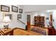 Inviting foyer with wooden floors, curated art collection, and display shelving for decor at 1513 Dellwood Dr, Raleigh, NC 27607