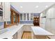 Well-lit kitchen with white cabinets, ample counter space, and stainless steel appliances at 1513 Dellwood Dr, Raleigh, NC 27607