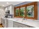 Traditional kitchen with wood-trimmed windows and ample natural light at 1513 Dellwood Dr, Raleigh, NC 27607