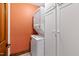 Conveniently located laundry room with stacked washer and dryer and storage space at 1513 Dellwood Dr, Raleigh, NC 27607