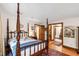 Comfortable main bedroom with wood floors and easy access to en suite bathroom at 1513 Dellwood Dr, Raleigh, NC 27607