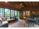 The enclosed sunroom features wood paneled walls and exposed wood beams at 1513 Dellwood Dr, Raleigh, NC 27607