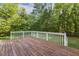 Wooden deck with white railing, perfect for outdoor relaxation and entertaining at 1601 Castalia Dr, Cary, NC 27513