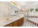 Bright bathroom featuring a double vanity, tiled floors, a glass-enclosed shower, and a separate tub at 1601 Castalia Dr, Cary, NC 27513