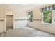 Cozy room featuring playful wallpaper, carpeting, and windows at 1601 Castalia Dr, Cary, NC 27513