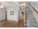 Bright foyer with hardwood floors, staircase, and view into other rooms at 1601 Castalia Dr, Cary, NC 27513