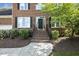 Brick home featuring a welcoming front entrance with beautiful landscaping and flower beds at 1601 Castalia Dr, Cary, NC 27513